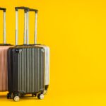 Pink Gray Black color luggage or baggage bag use for transportation travel and leisure on yellow isolated background