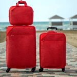 set of red suitcases and bags